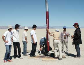 Students helping adjust launcher